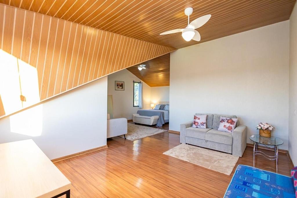 Suíte com cama de casal e sala de estar integrada